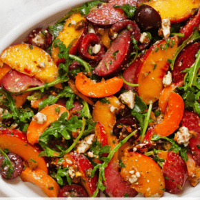 Stone fruit salad on an oval-shaped serving plate.