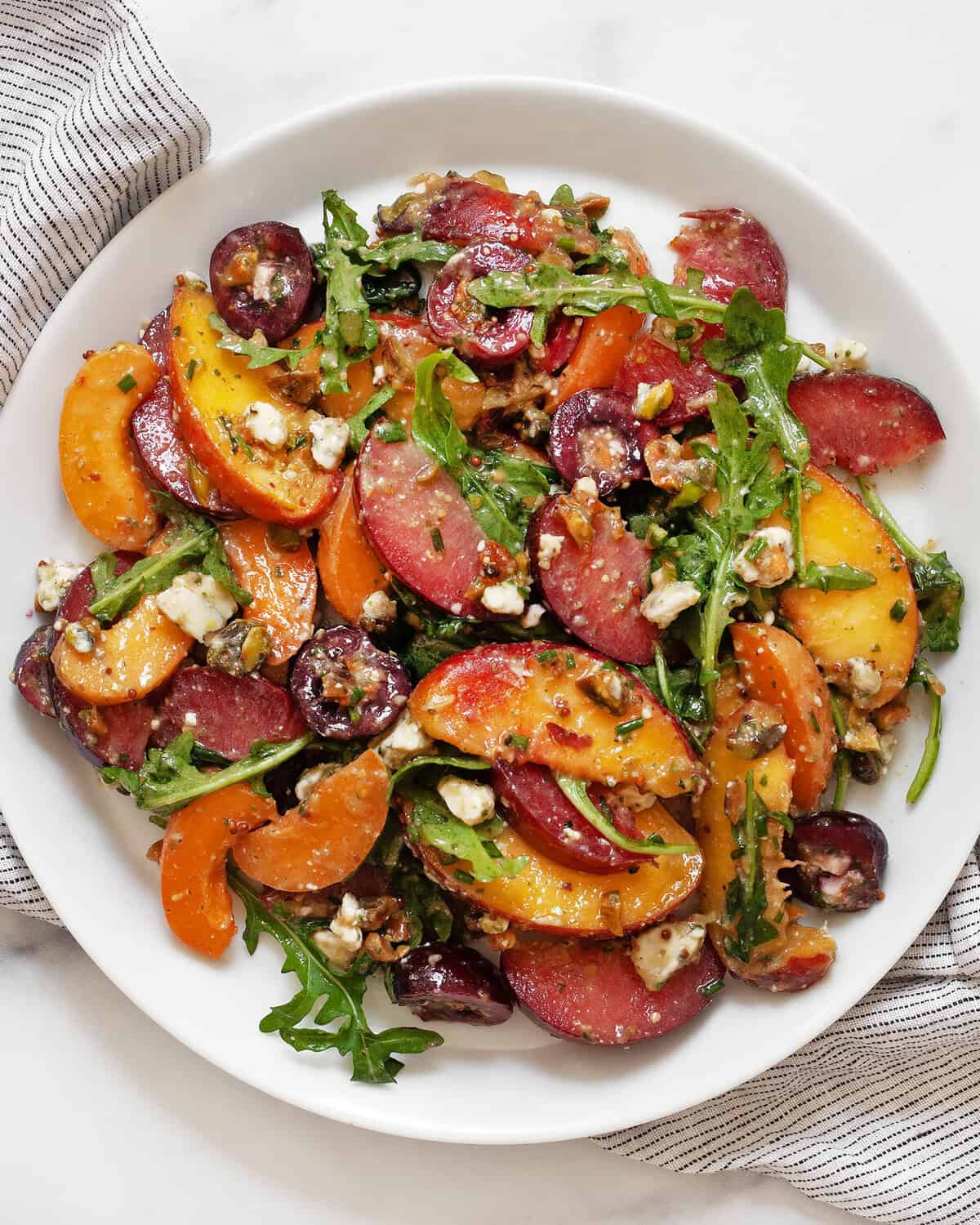Stone fruit salad on a plate.