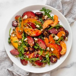 Stone fruit salad on a plate.