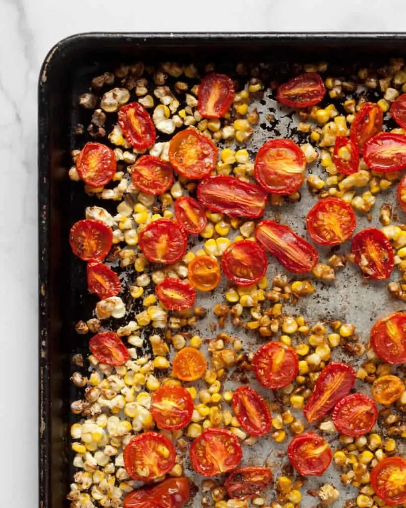 Roasted corn and tomatoes on a sheet pan