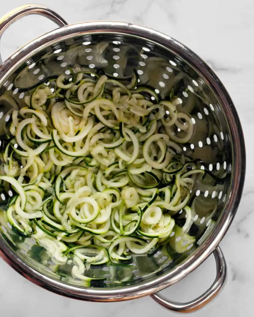 Draining spiralized zucchini in a colander