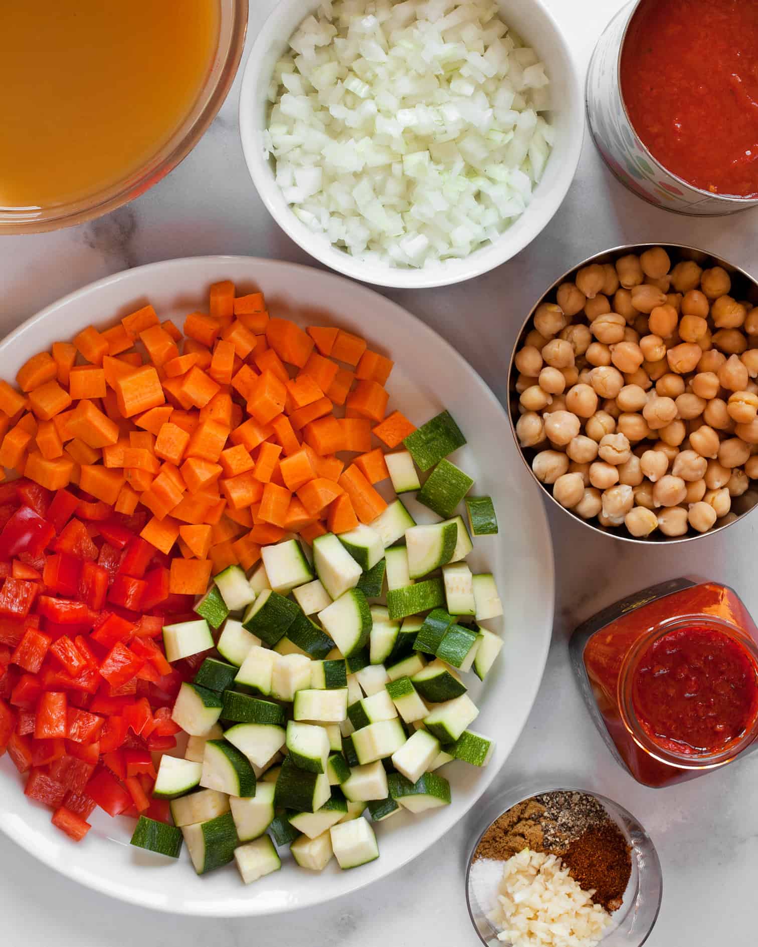 Carrots, red peppers, zucchini, harissa and other soup ingredients