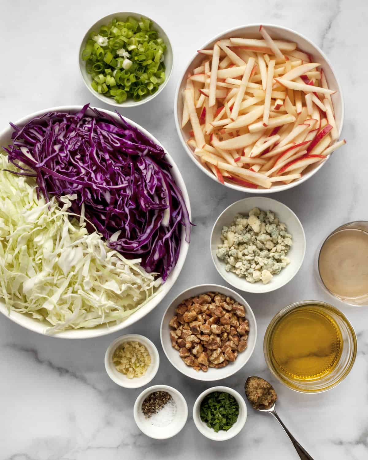 Ingredients including cabbage, apples, walnuts, blue cheese and scallions.