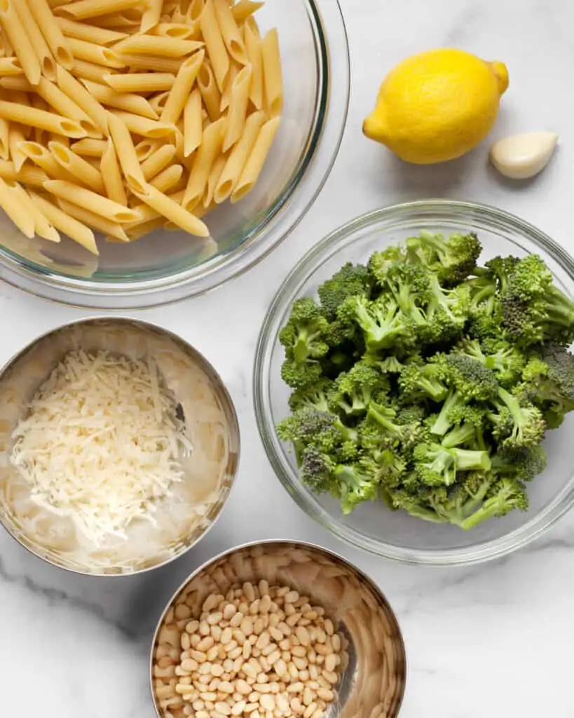 Broccoli pasta ingredients including penne, lemon, garlic and cheese