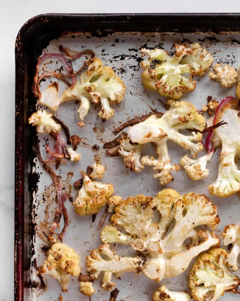 Roasted cauliflower and onions on a sheet pan
