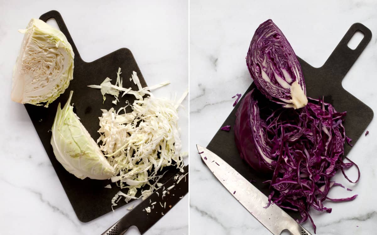 Shredded green and red cabbage on cutting boards.