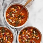 Three bowls of vegetarian minestrone soup.