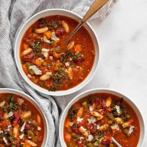 Three bowls of vegetarian minestrone soup.