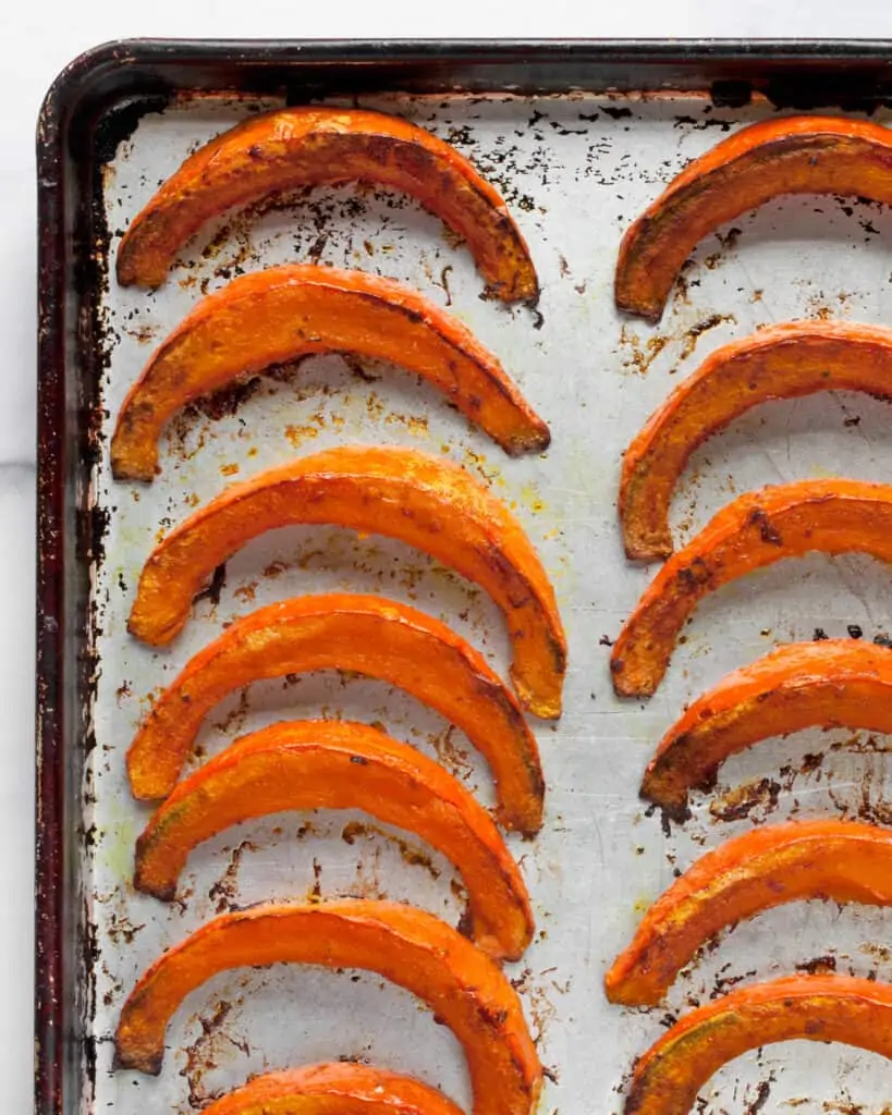 Roasted squash wedges on sheet pan