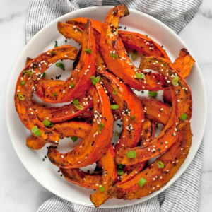 Roasted squash wedges on a plate.