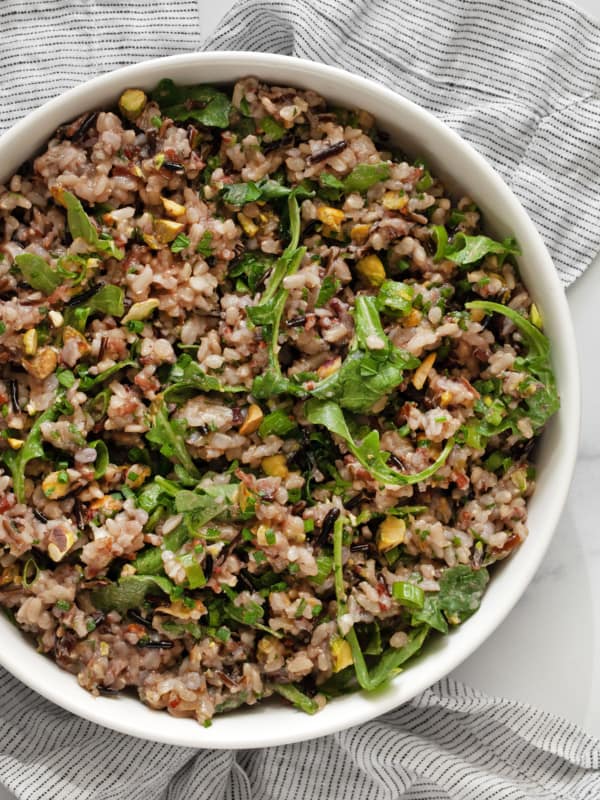 Arugula wild rice salad in a bowl.