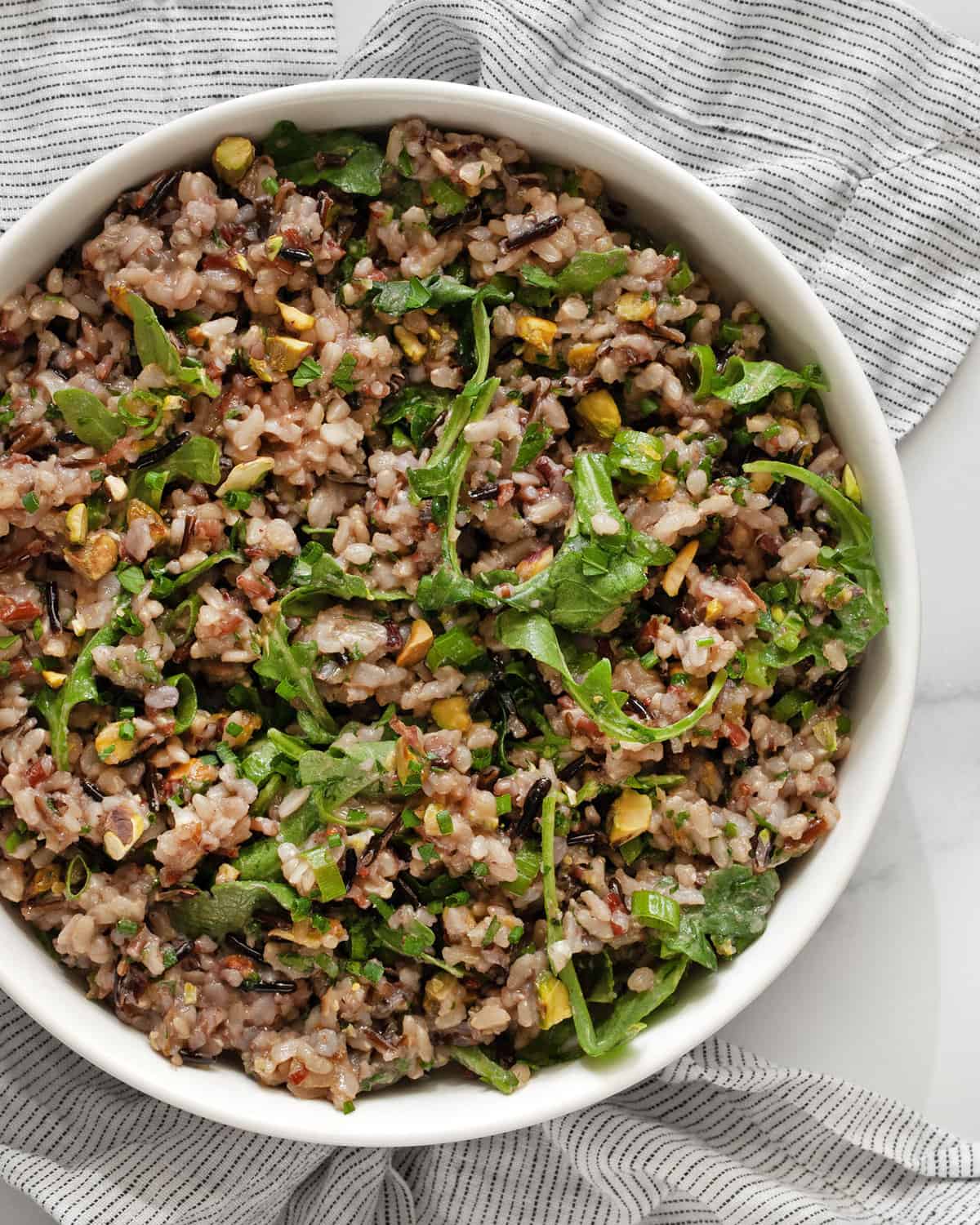 Arugula wild rice salad in a bowl.