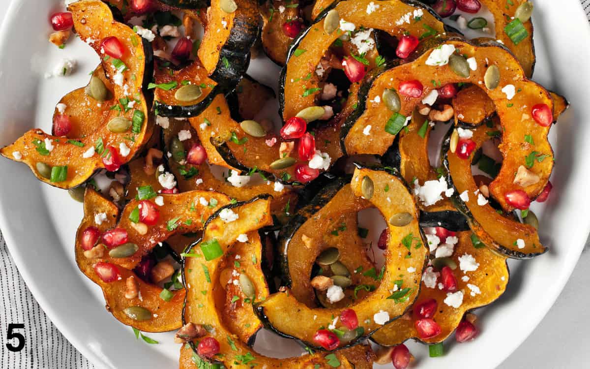 Roasted acorn squash topped with pumpkin seeds, pomegranate seeds and goat cheese.