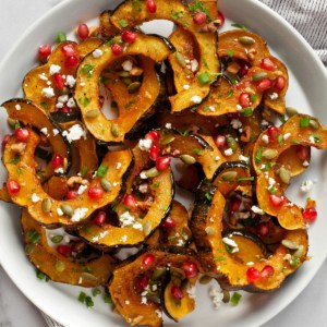 Maple acorn squash with pomegranate seeds, goat cheese and pumpkin seeds.