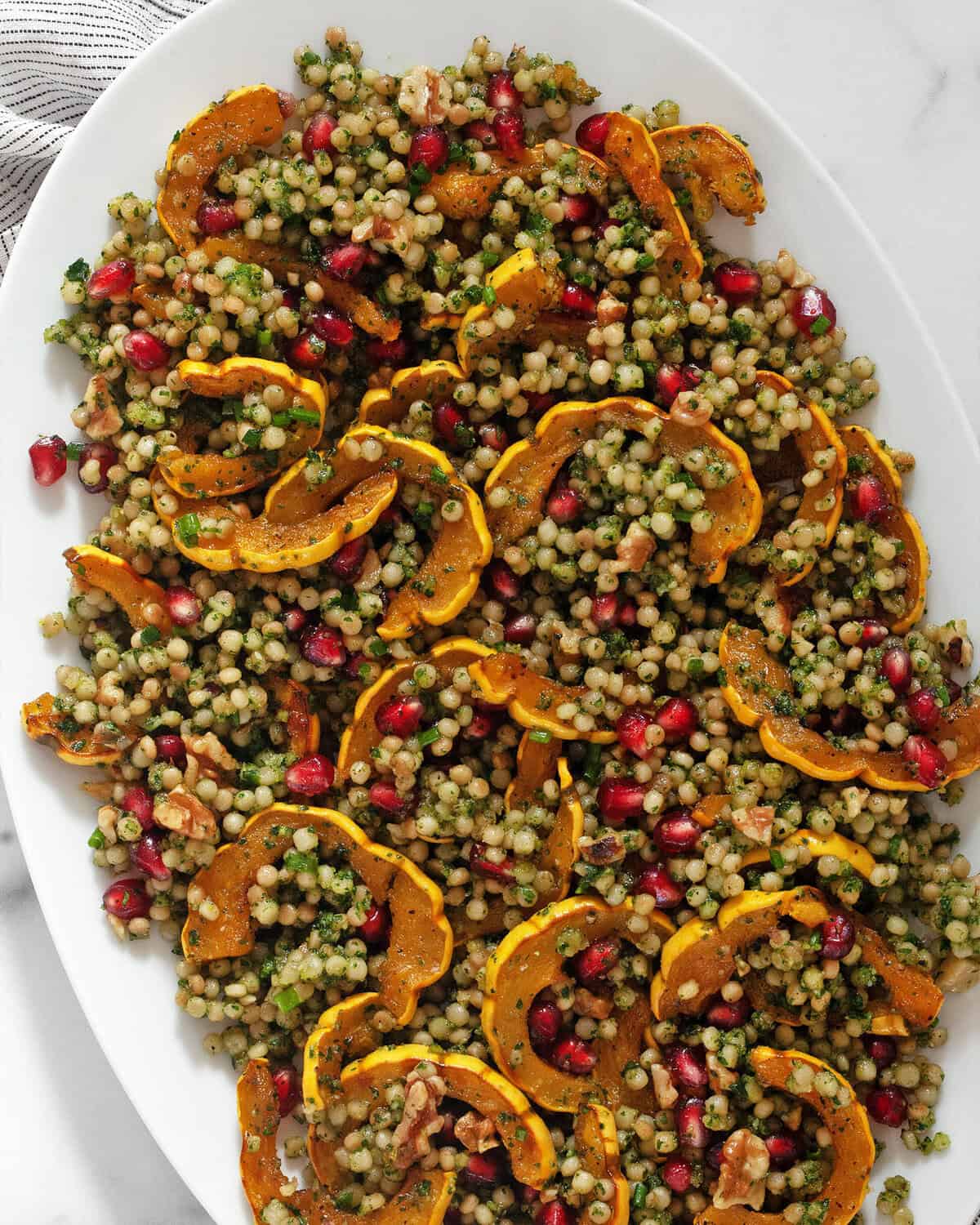 Roasted delicata squash couscous on a serving platter.