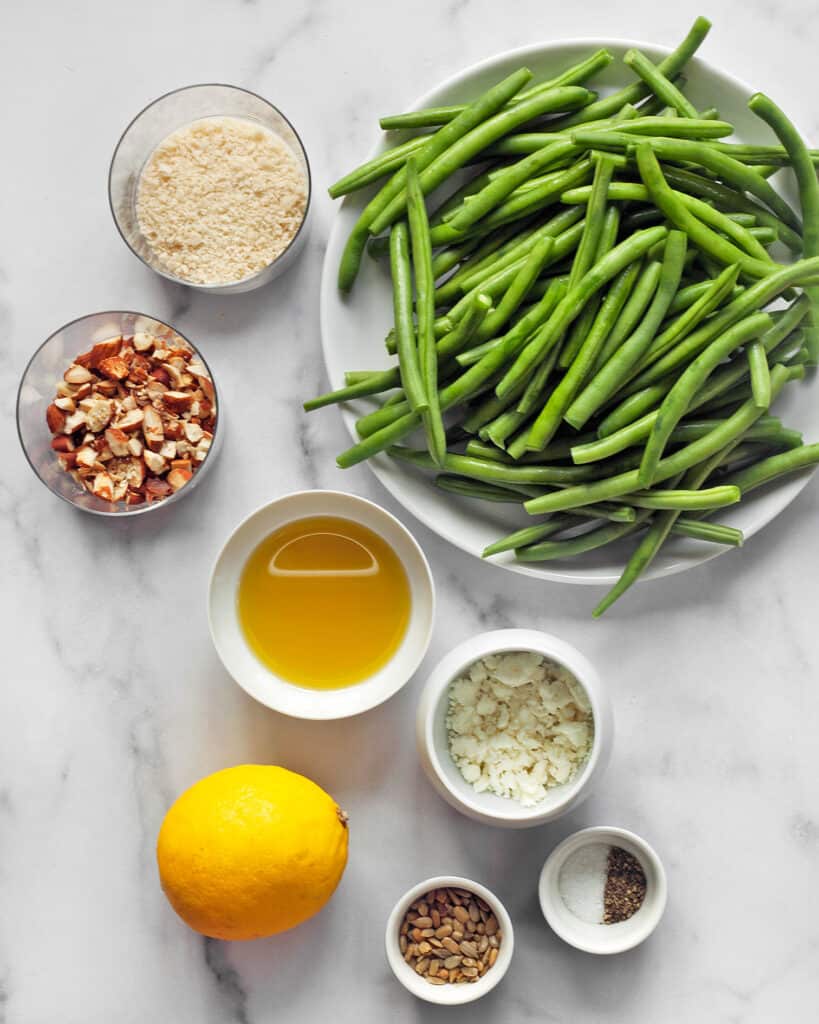 Ingredients including green beans, breadcrumbs, almonds, olive oil, feta and lemon