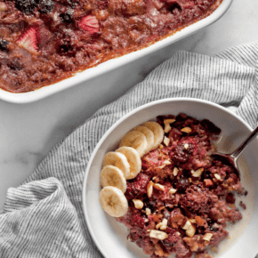 Berry baked steel-cut oatmeal spooned into a bowl.