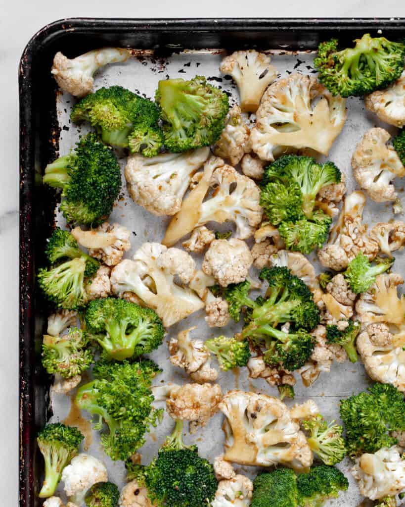 Broccoli and cauliflower florets on a sheet pan