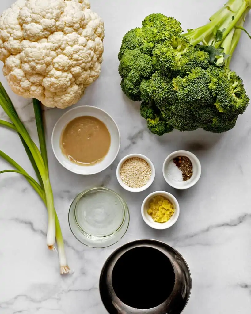 Ingredients including broccoli, cauliflower, soy sauce, ginger and tahini