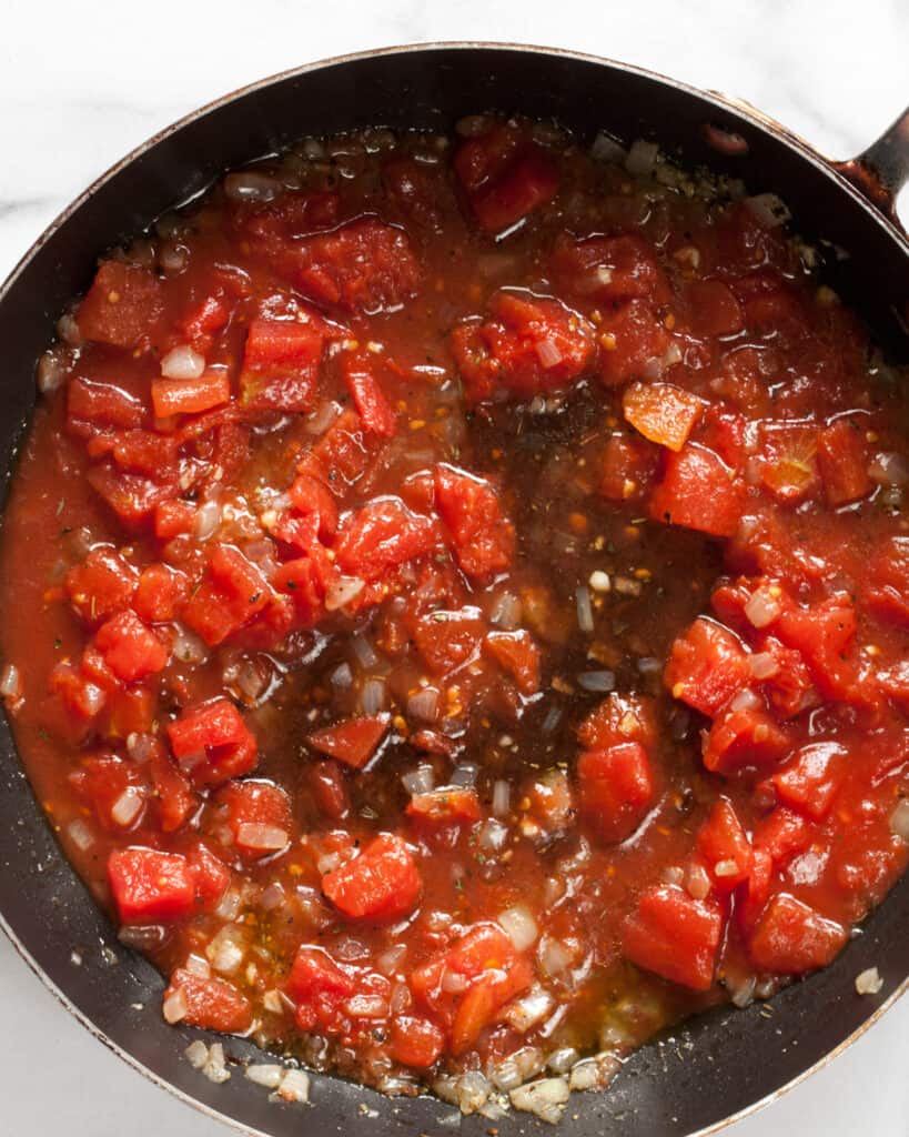 Pour in the diced tomatoes and balsamic vinegar