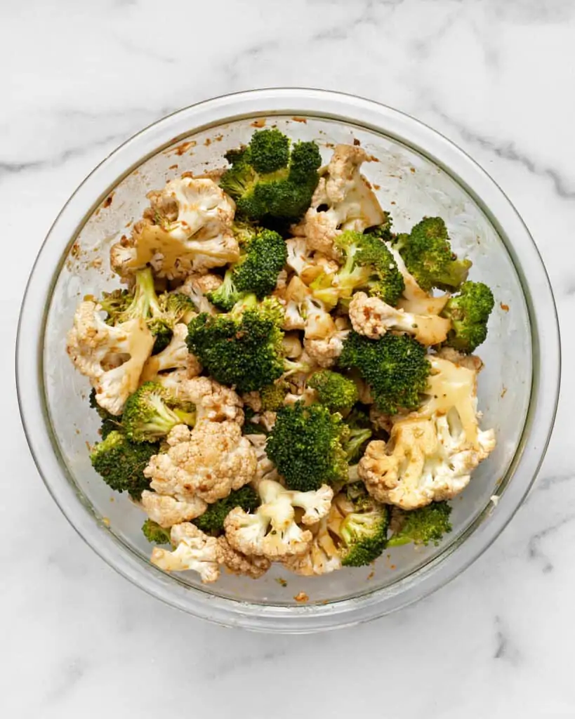 Toss the broccoli and cauliflower in the tahini souy marinade