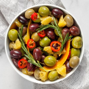 Citrus and herb marinated olives in a bowl.