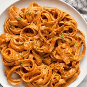 Creamy tomato spinach pasta on a plate.