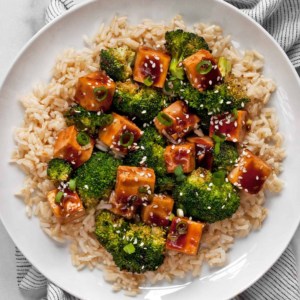 Honey garlic tofu with broccoli and brown rice on a plate
