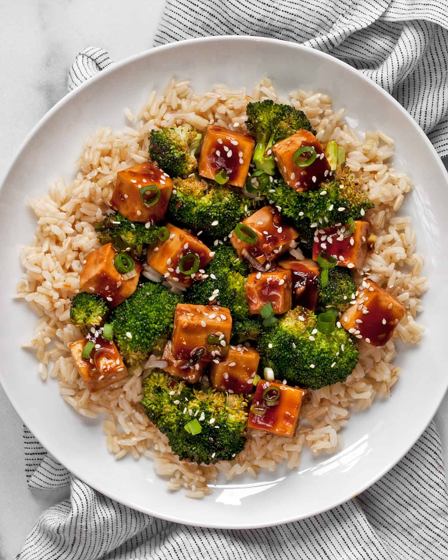 Honey garlic tofu with broccoli and brown rice on a plate