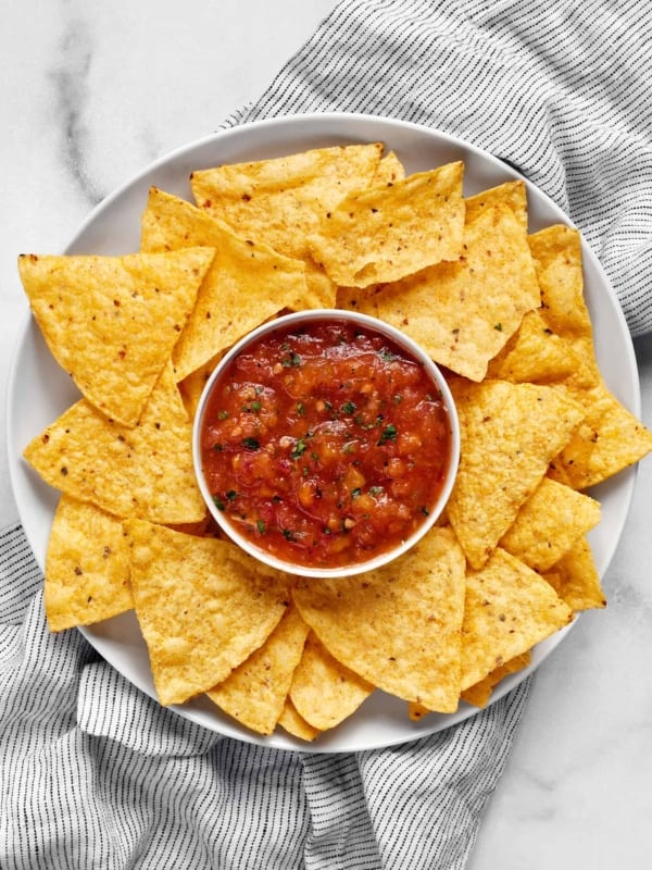 Spicy habanero salsa in a bowl with chips on a plate