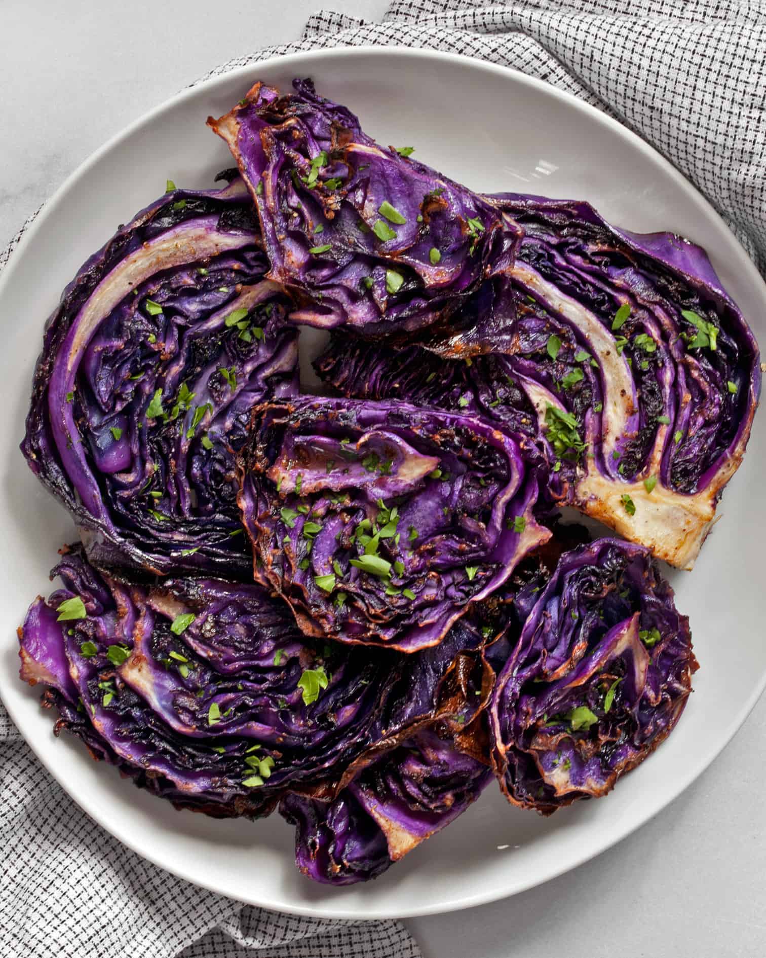 Slices of roasted red cabbage on a plate.