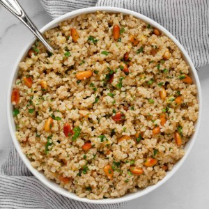 Lemon quinoa in a bowl with a serving spoon.