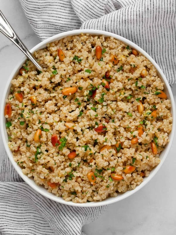 Lemon quinoa in a bowl with a serving spoon.