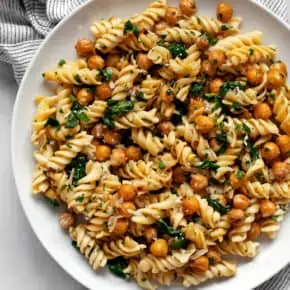 Chickpea pasta with spinach on a plate.