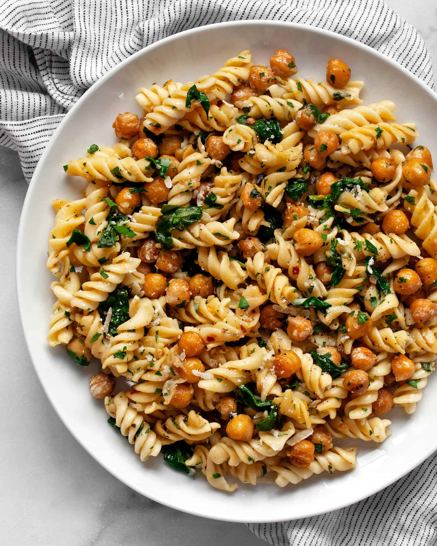 Chickpea pasta with spinach on a plate.