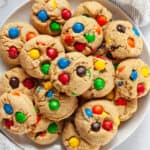 Peanut butter M&M cookies on a plate.