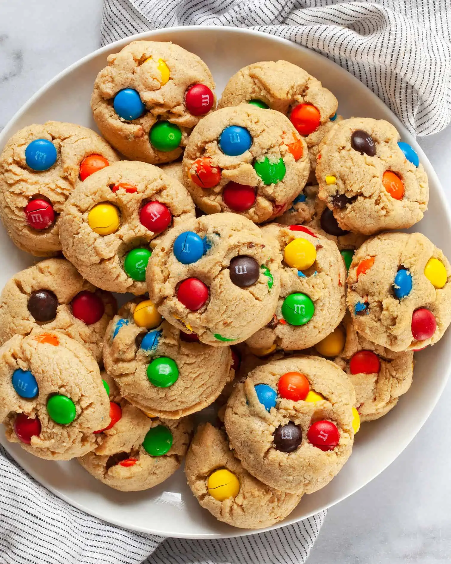 Peanut butter M&M cookies on a plate.
