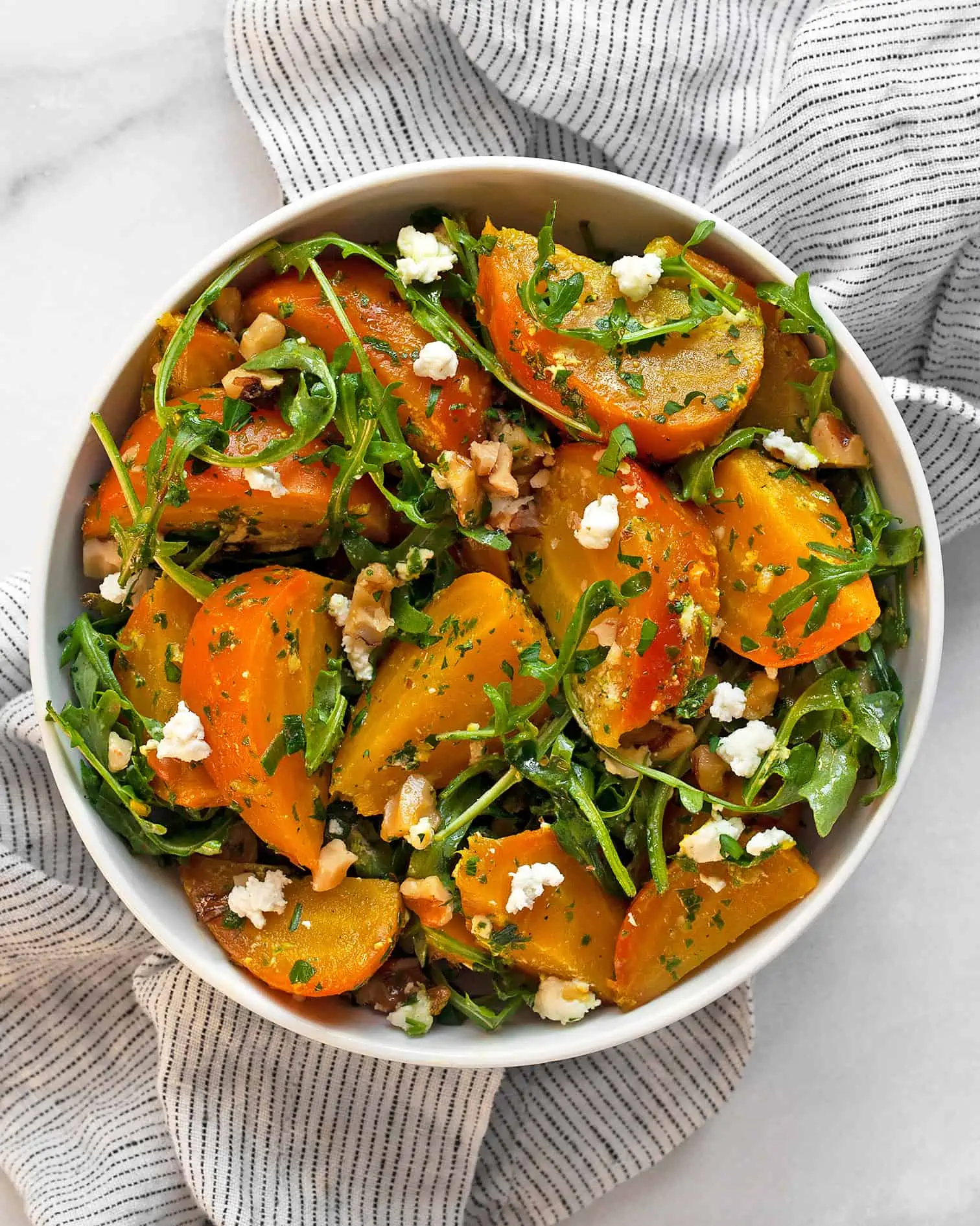 Roasted golden beet salad in a bowl.