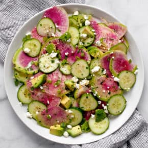 Radish salad with cucumbers and avocados on a plate.