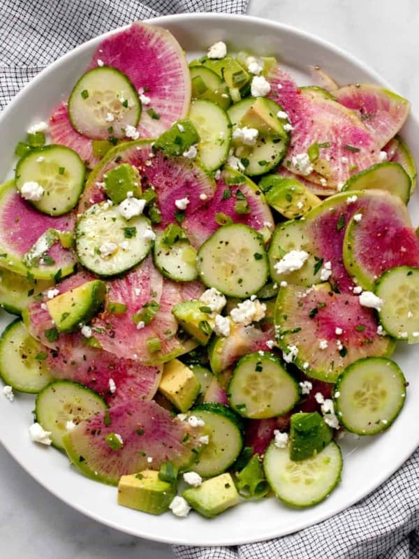 Radish salad with cucumbers and avocados on a plate.