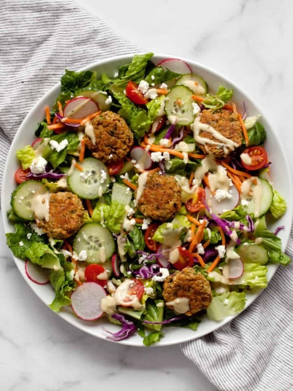 Salad with baked falafel on a plate.