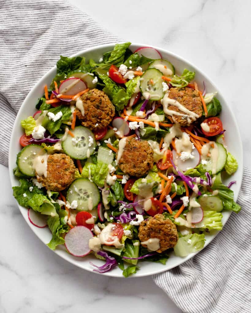 Salad with baked falafel on a plate.