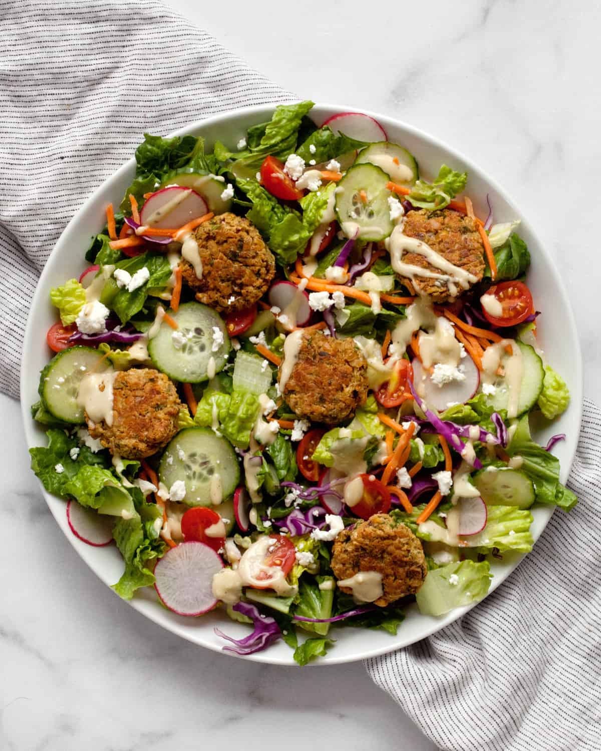 Salad with baked falafel on a plate.