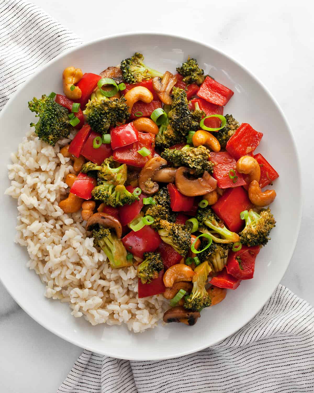 Veggie stir-fry with cashews and rice  on a plate.