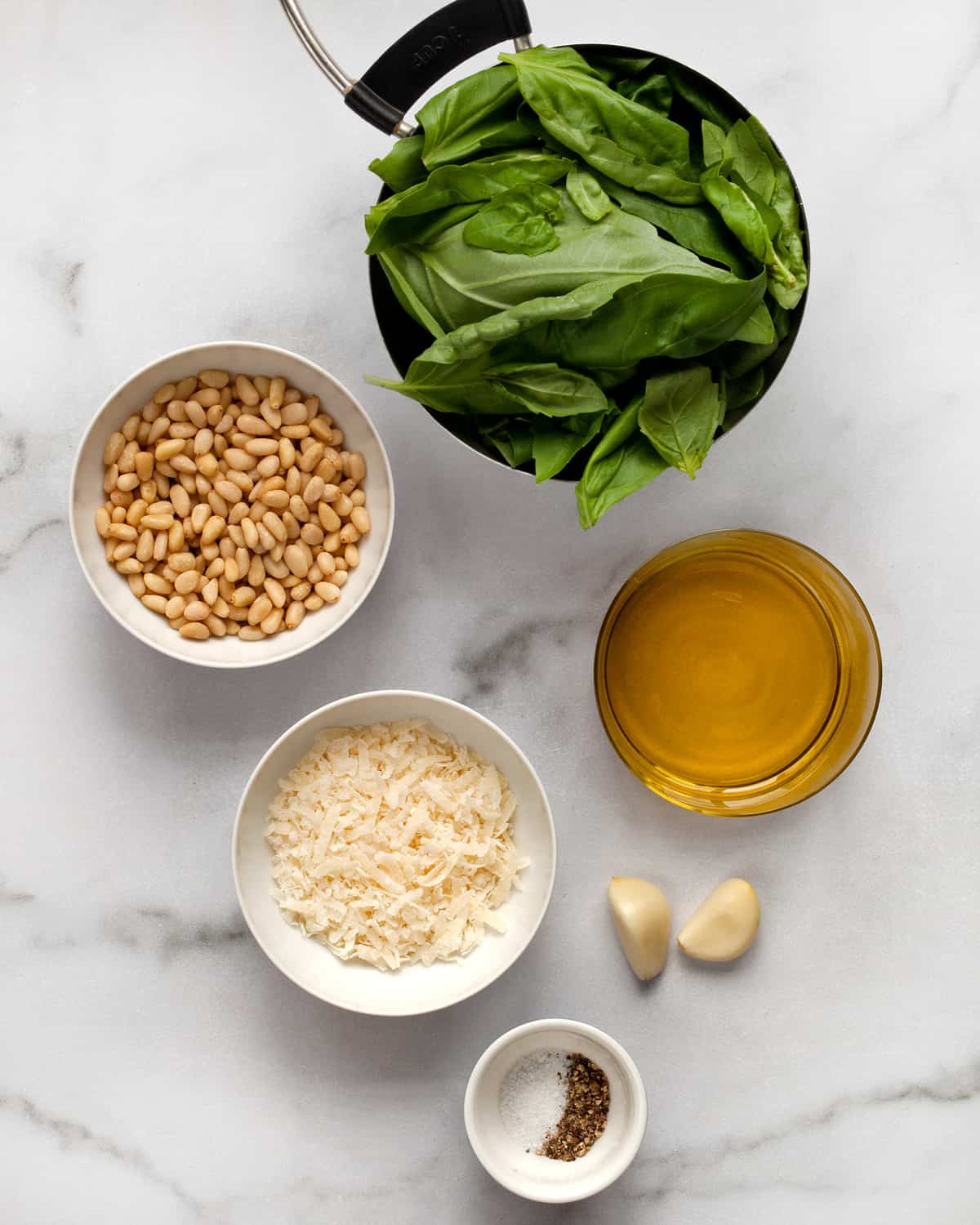 Ingredients including basil, pine nuts, garlic, Parmesan and olive oil