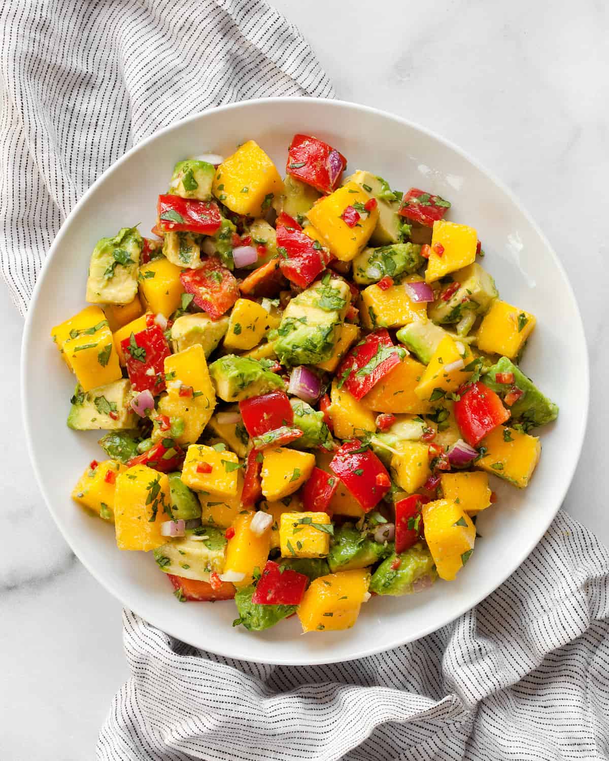 Mango salad with avocado on a plate.