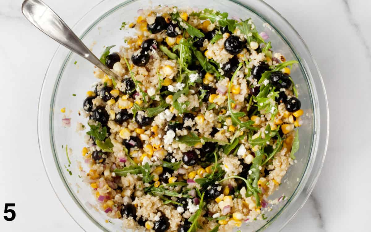 Salad ingredients tossed in a bowl.