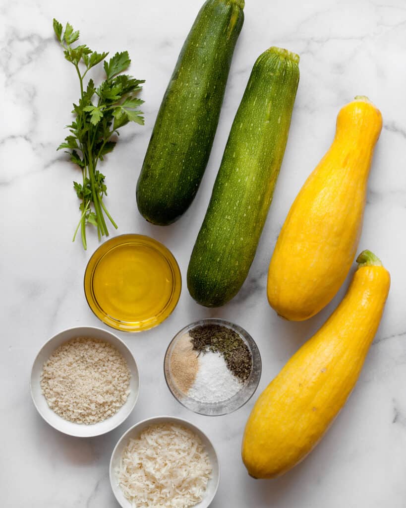 Ingredients including zucchini, yellow squash, panko, parmesan, olive oil and spices