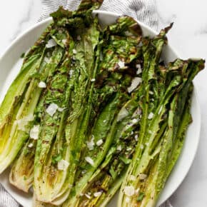 Grilled romaine hearts on a plate.