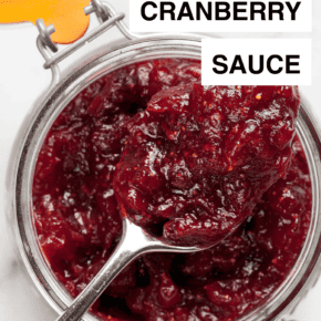Cranberry sauce in a jar with a spoon.
